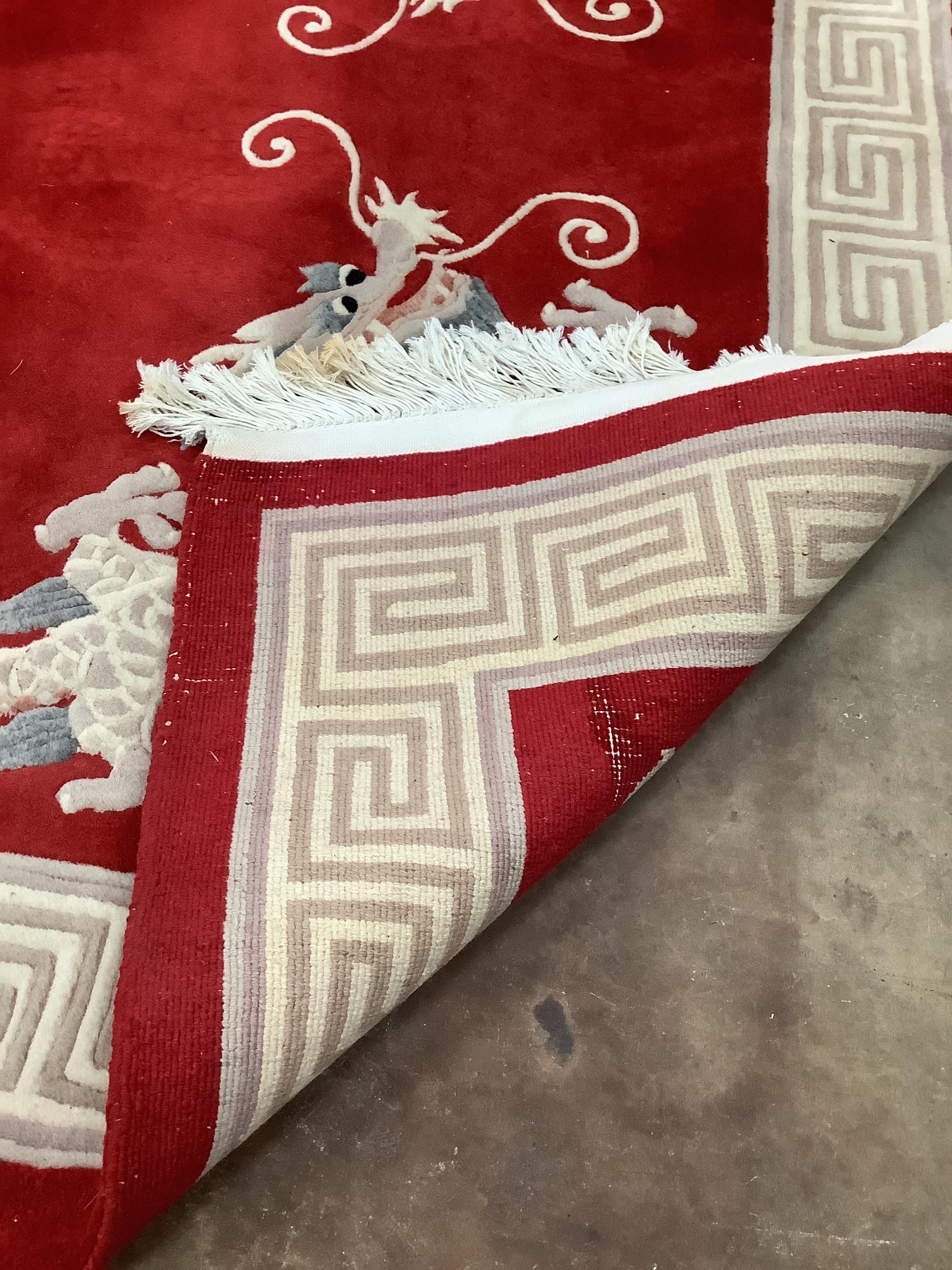 A Chinese dragon and pearl red ground carpet, 280 x 185cm